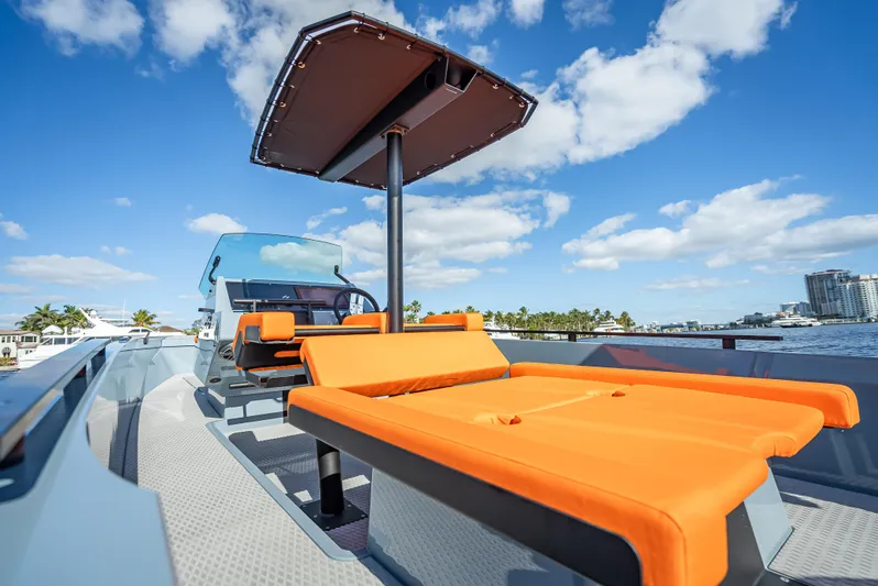  Yacht Photos Pics 2024 Goldfish 28 Tender with orange seating and canopy on a sunny day.