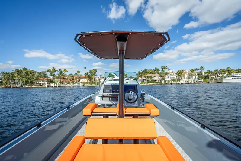  Yacht Photos Pics 2024 Goldfish 28 Tender boat with orange seating on a sunny day.
