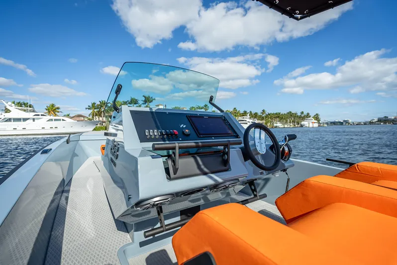  Yacht Photos Pics Goldfish 28 Tender 2024 model boat dashboard with orange seats on a sunny day.