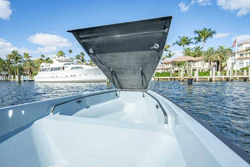  Yacht Photos Pics 2024 Goldfish 28 Tender boat with open storage compartment on a sunny day.