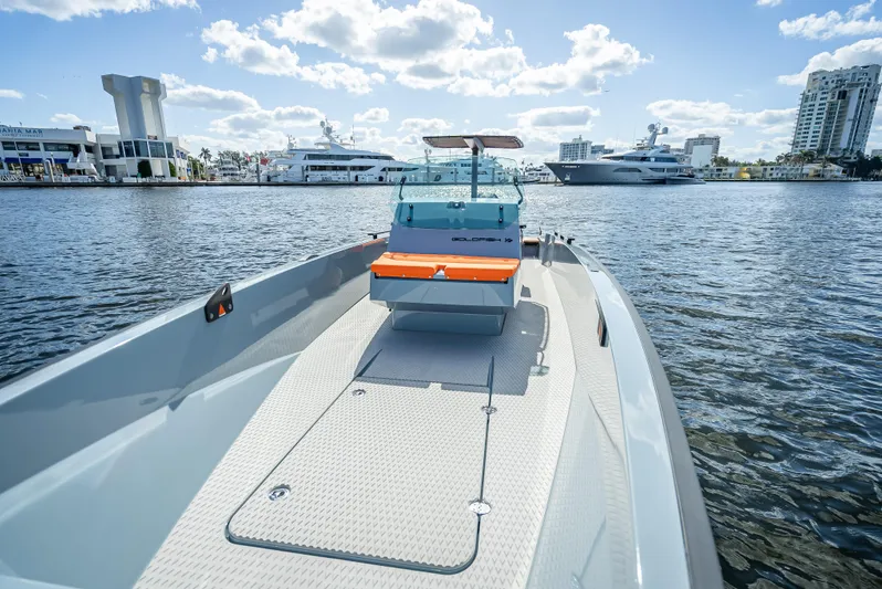  Yacht Photos Pics 2024 Goldfish 28 Tender boat on water with cityscape background.