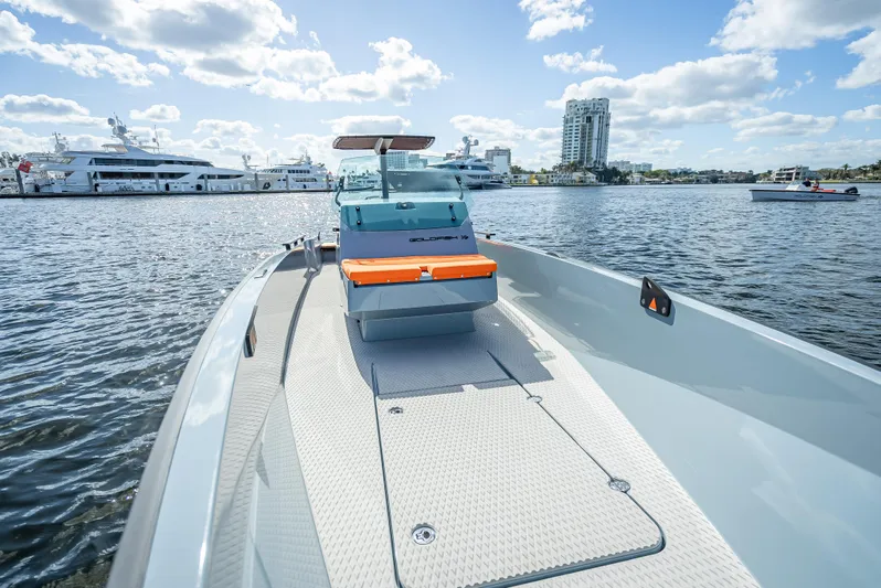  Yacht Photos Pics 2024 Goldfish 28 Tender boat on water with cityscape background.
