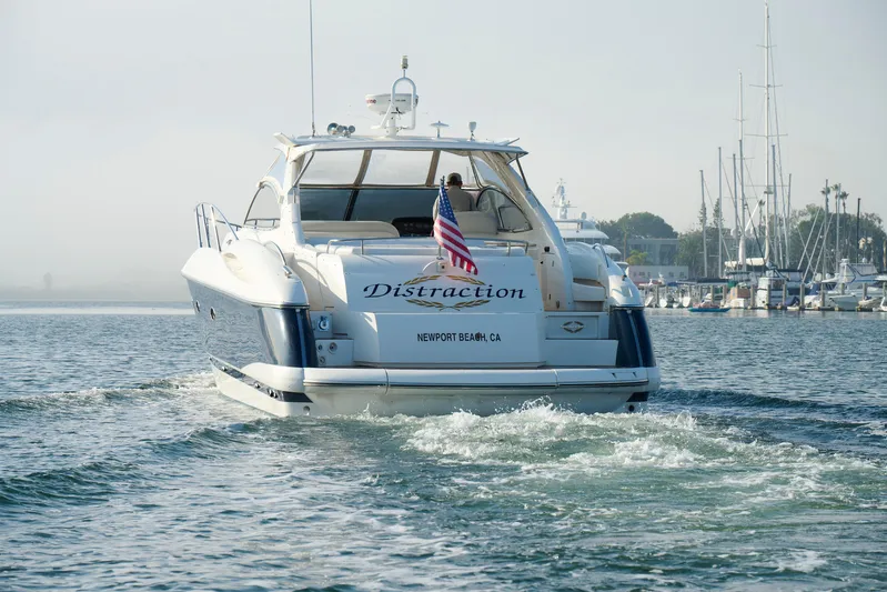 Distraction Yacht Photos Pics Sunseeker Camargue 50 yacht cruising in Newport Beach, 2000 model, with American flag.