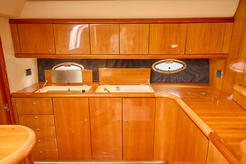 Distraction Yacht Photos Pics Luxurious wooden interior of 2000 Sunseeker Camargue 50 yacht kitchen.