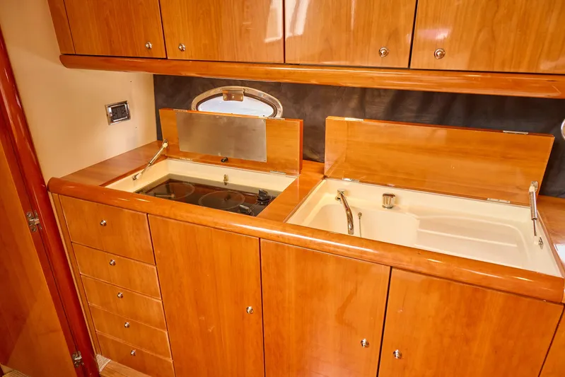 Distraction Yacht Photos Pics Luxurious wooden kitchen interior on a 2000 Sunseeker Camargue 50 yacht.