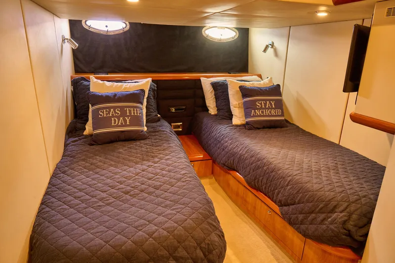 Distraction Yacht Photos Pics Twin cabin in 2000 Sunseeker Camargue 50 yacht with nautical-themed pillows.