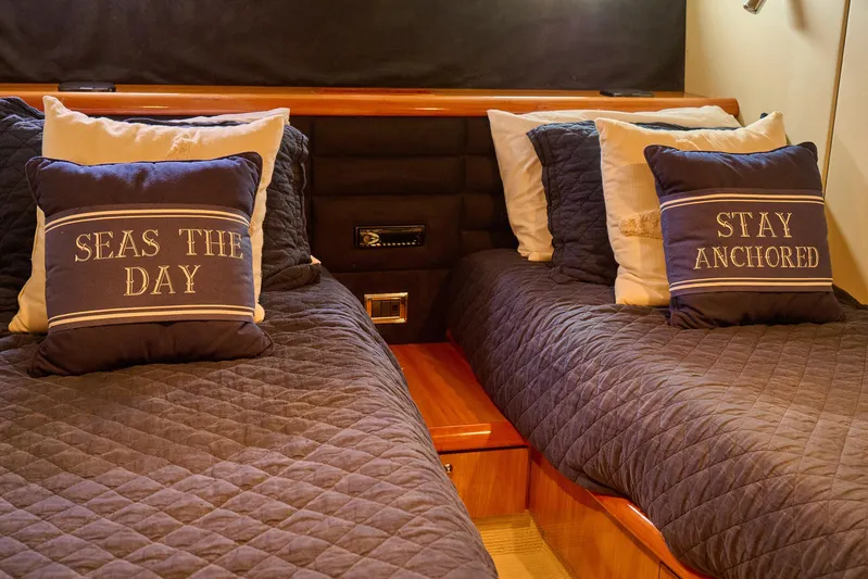 Distraction Yacht Photos Pics Cozy cabin interior of 2000 Sunseeker Camargue 50 with nautical-themed pillows.