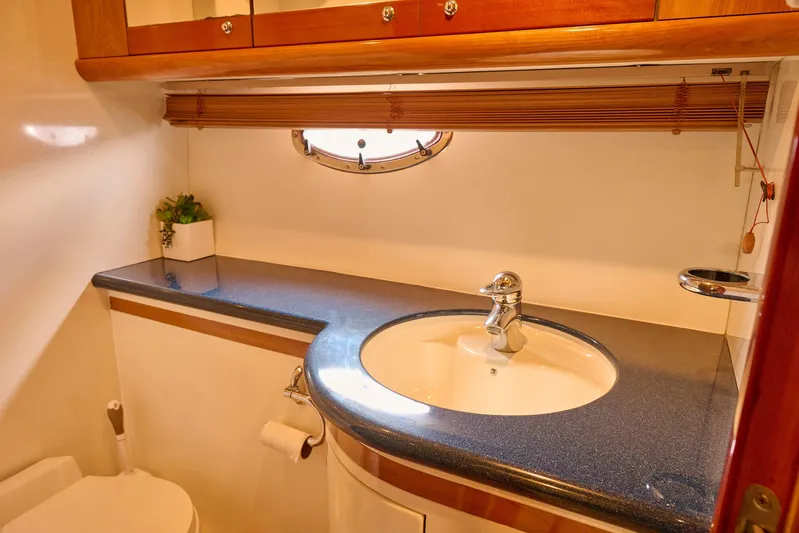 Distraction Yacht Photos Pics Luxurious bathroom in 2000 Sunseeker Camargue 50 yacht with sleek sink and wooden accents.