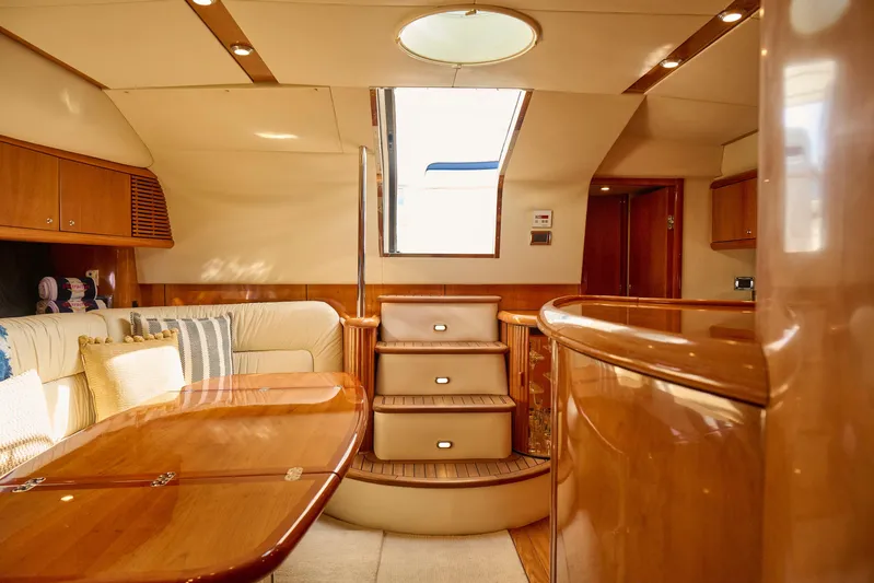 Distraction Yacht Photos Pics Luxurious interior of 2000 Sunseeker Camargue 50 yacht with elegant wood finishes.