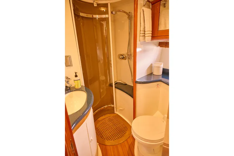 Distraction Yacht Photos Pics Bathroom interior of 2000 Sunseeker Camargue 50 yacht with shower and sink.