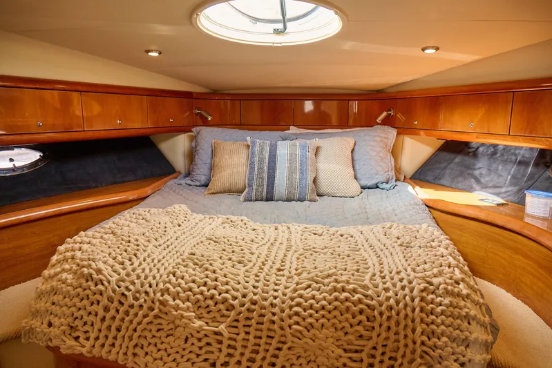 Distraction Yacht Photos Pics Luxurious cabin interior of 2000 Sunseeker Camargue 50 yacht with cozy bedding.