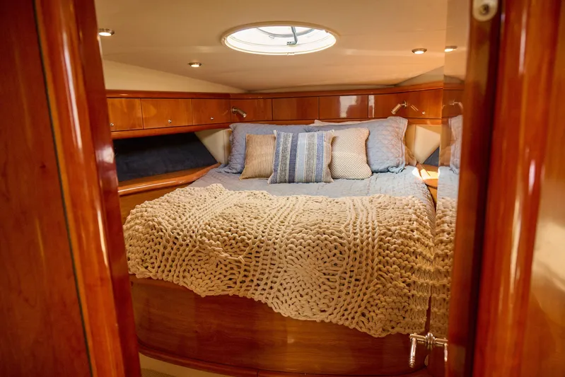 Distraction Yacht Photos Pics Luxurious cabin interior of 2000 Sunseeker Camargue 50 yacht with cozy bedding.