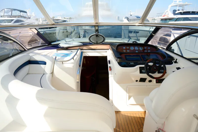 Distraction Yacht Photos Pics Interior view of 2000 Sunseeker Camargue 50 yacht cockpit with steering wheel and seating.