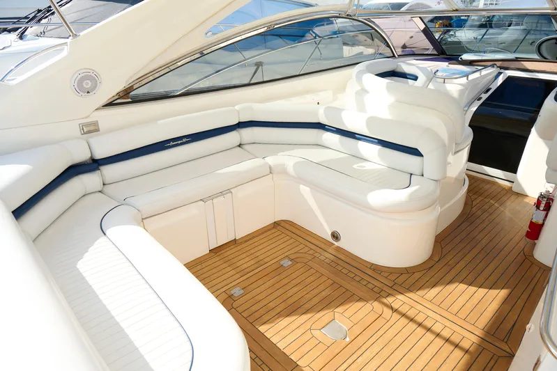 Distraction Yacht Photos Pics Luxurious interior of 2000 Sunseeker Camargue 50 yacht with elegant seating and wooden flooring.