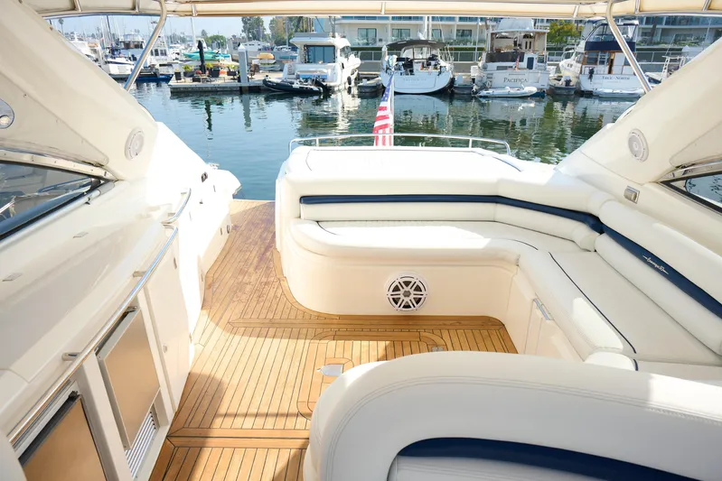 Distraction Yacht Photos Pics Luxurious Sunseeker Camargue 50 yacht interior with elegant seating, docked at a marina.