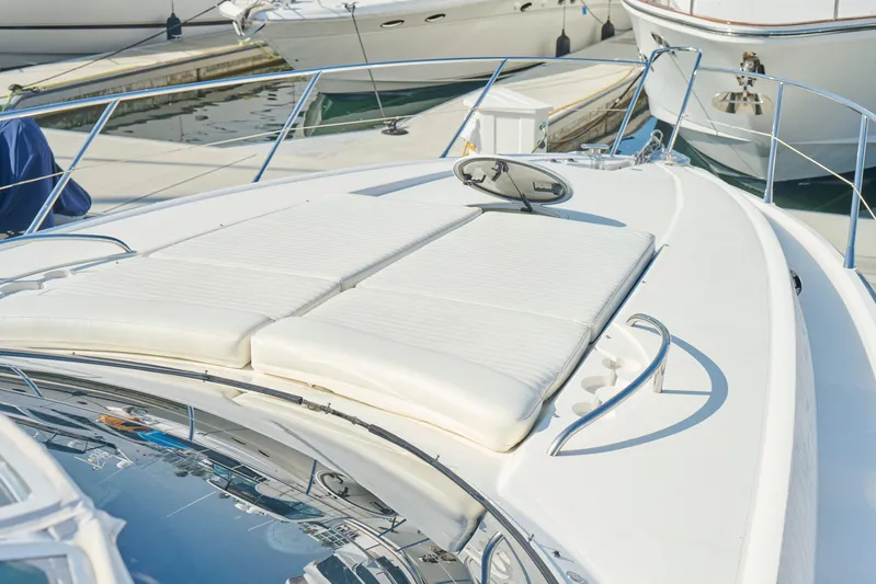 Distraction Yacht Photos Pics Sunseeker Camargue 50 yacht, 2000 model, featuring a spacious sun deck at the marina.
