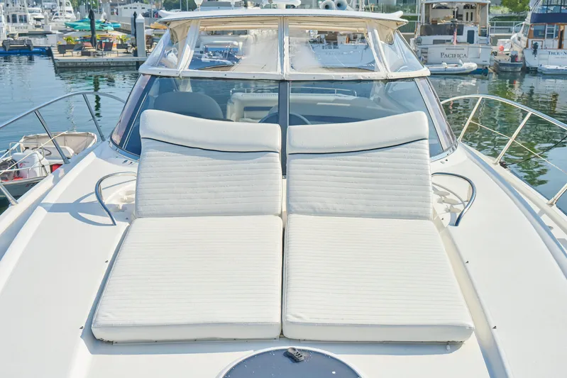 Distraction Yacht Photos Pics Sunseeker Camargue 50 yacht, 2000 model, with sun loungers at marina.