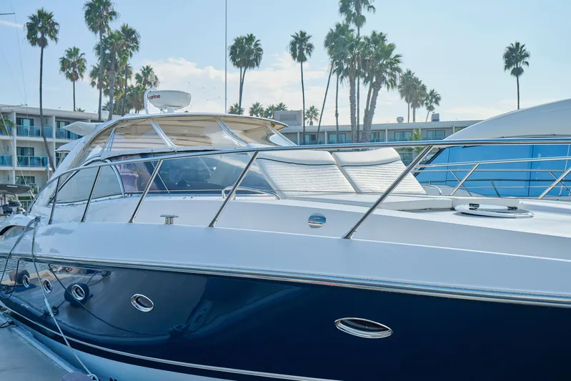 Distraction Yacht Photos Pics Luxury Sunseeker Camargue 50 yacht docked, surrounded by palm trees, 2000 model.