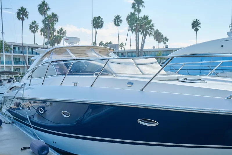 Distraction Yacht Photos Pics Sunseeker Camargue 50 yacht, 2000 model, docked with palm trees in the background.