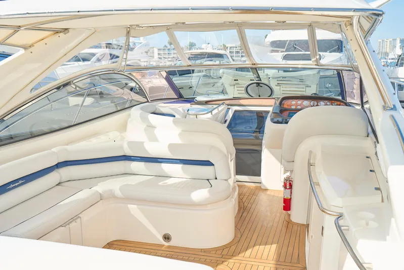 Distraction Yacht Photos Pics Luxurious Sunseeker Camargue 50 yacht interior, featuring elegant white seating and modern dashboard.