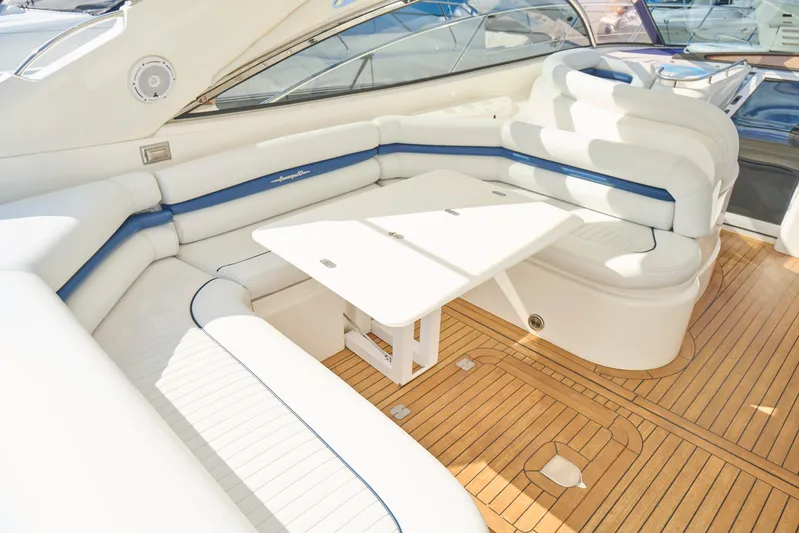 Distraction Yacht Photos Pics Luxurious Sunseeker Camargue 50 yacht interior with white seating and wooden flooring, 2000 model.