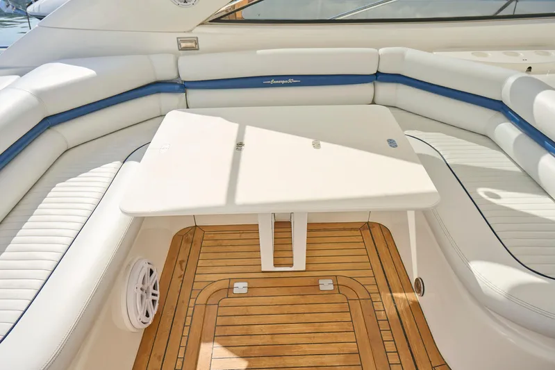 Distraction Yacht Photos Pics Sunseeker Camargue 50 yacht interior, featuring white seating and wooden flooring, 2000 model.