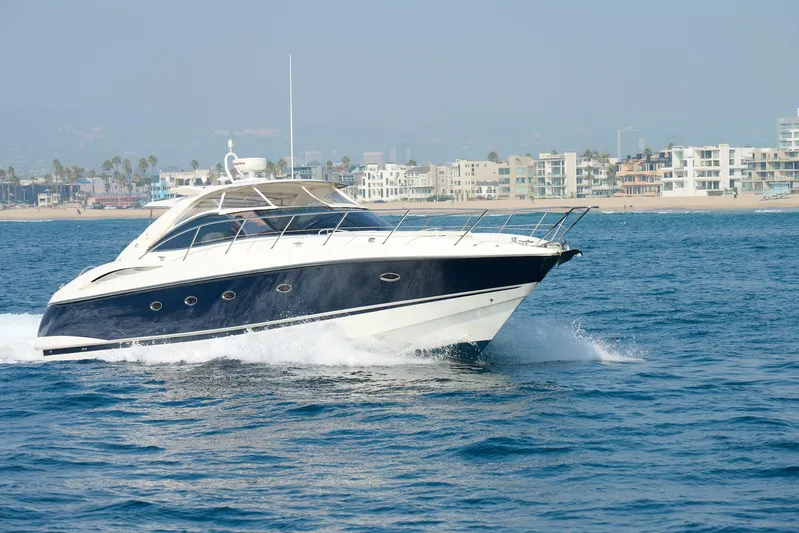 Distraction Yacht Photos Pics Sunseeker Camargue 50 yacht cruising near coastal city, 2000 model.