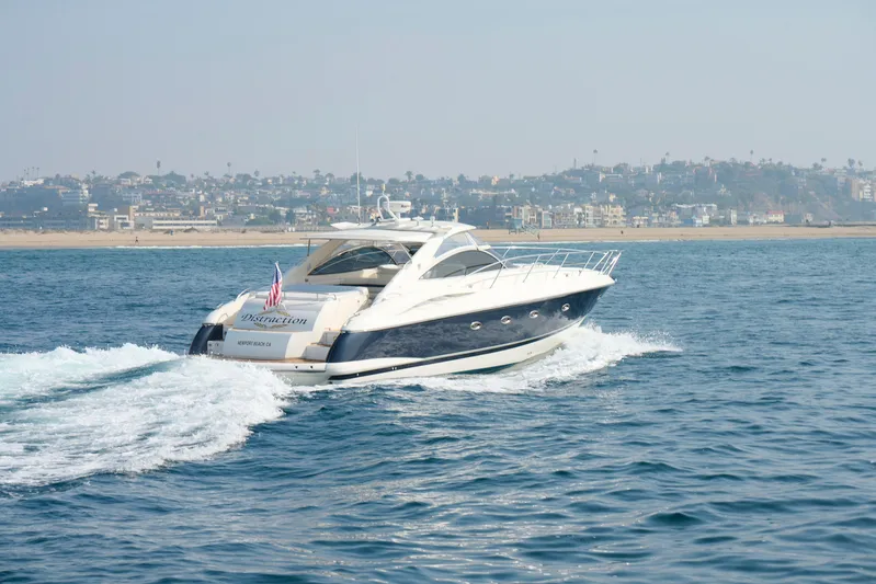 Distraction Yacht Photos Pics Sunseeker Camargue 50 yacht cruising near coastline, 2000 model.