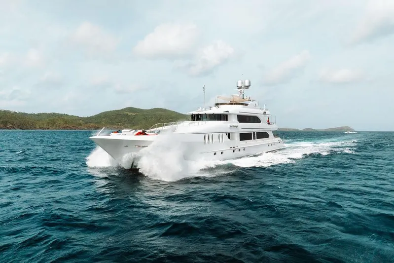 Just Enough Yacht Photos Pics Luxurious 2012 Ares Custom Marine 141 yacht cruising through vibrant blue ocean waters.