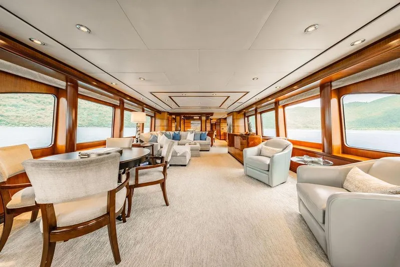 Just Enough Yacht Photos Pics Luxurious interior of 2012 Ares Custom Marine Custom 141 yacht with elegant seating and panoramic windows.