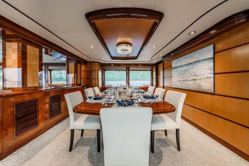 Just Enough Yacht Photos Pics Luxurious dining area on 2012 Ares Custom Marine Custom 141 yacht, featuring elegant wood paneling.