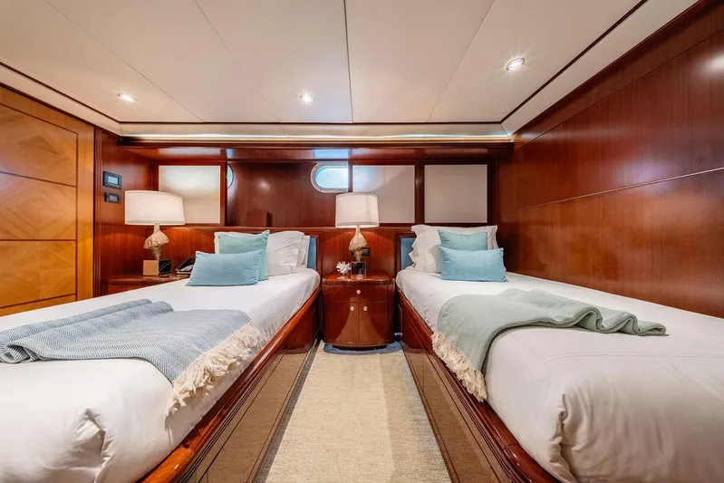 Just Enough Yacht Photos Pics Luxurious twin cabin on 2012 Ares Custom Marine Custom 141 yacht, featuring elegant wood paneling.