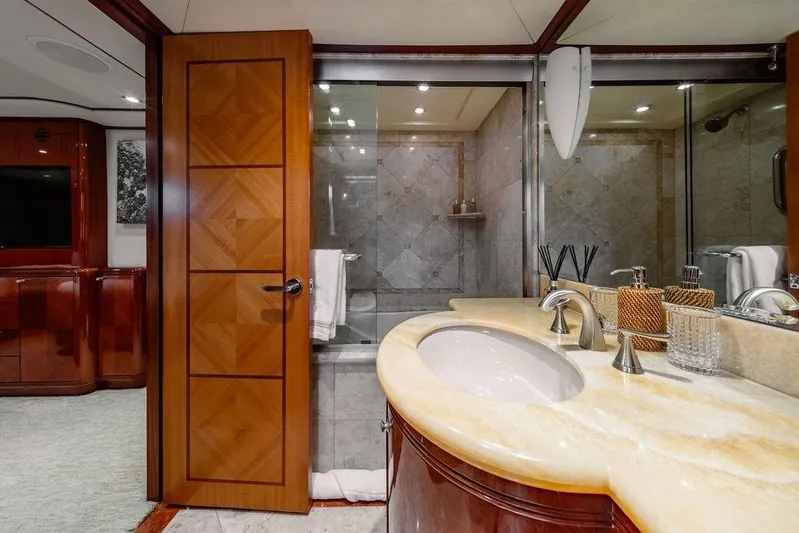 Just Enough Yacht Photos Pics Luxurious bathroom interior on 2012 Ares Custom Marine Custom 141 yacht, featuring elegant wood and marble finishes.