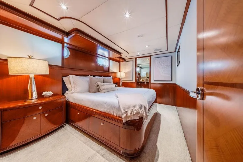 Just Enough Yacht Photos Pics Luxurious bedroom interior of 2012 Ares Custom Marine 141 yacht with elegant wood finishes.