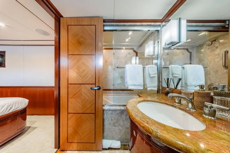 Just Enough Yacht Photos Pics Luxurious bathroom on 2012 Ares Custom Marine Custom 141 yacht, featuring elegant wood and marble finishes.