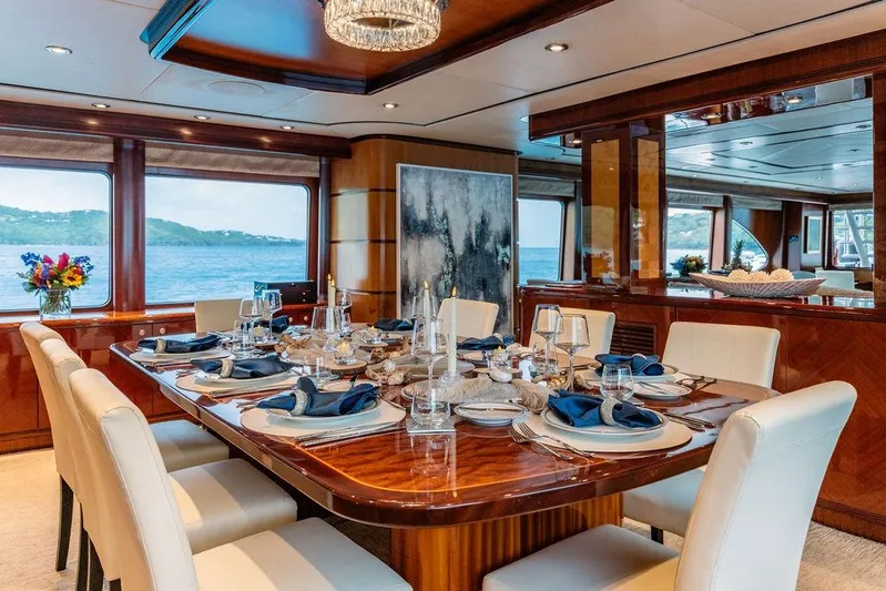 Just Enough Yacht Photos Pics Luxurious dining area on 2012 Ares Custom Marine Custom 141 yacht with elegant table setting.