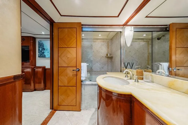 Just Enough Yacht Photos Pics Luxurious bathroom on 2012 Ares Custom Marine Custom 141 yacht, featuring elegant wood and marble finishes.