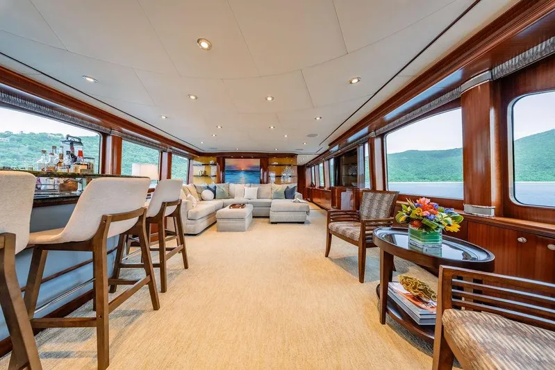 Just Enough Yacht Photos Pics Luxurious interior of 2012 Ares Custom Marine Custom 141 yacht with elegant seating and bar area.