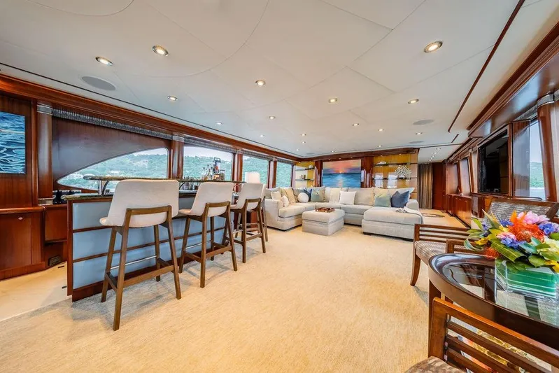 Just Enough Yacht Photos Pics Luxurious interior of 2012 Ares Custom Marine Custom 141 yacht with elegant seating and bar area.