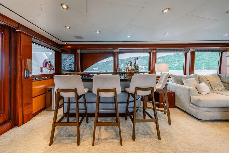 Just Enough Yacht Photos Pics Luxurious interior of 2012 Ares Custom Marine Custom 141 yacht with bar and seating area.