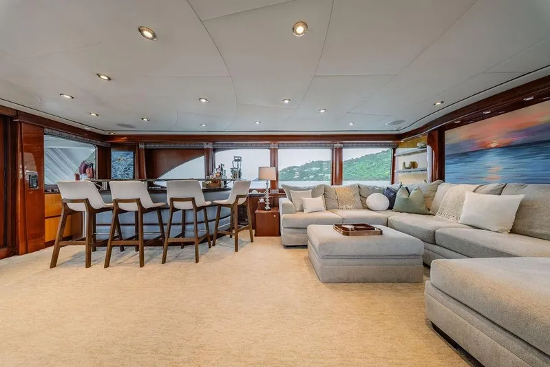 Just Enough Yacht Photos Pics Luxurious interior of 2012 Ares Custom Marine 141 yacht with elegant seating and bar area.