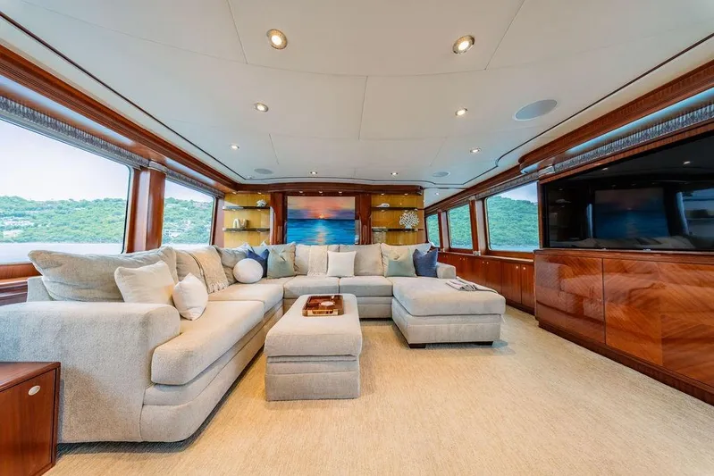 Just Enough Yacht Photos Pics Luxurious interior of 2012 Ares Custom Marine 141 yacht with plush seating and elegant wood finishes.