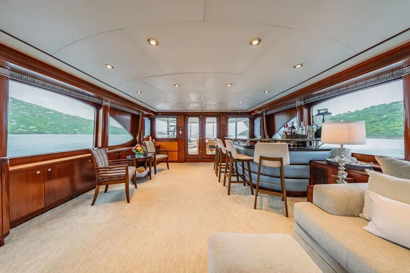 Just Enough Yacht Photos Pics Luxurious interior of 2012 Ares Custom Marine yacht, featuring elegant seating and panoramic windows.