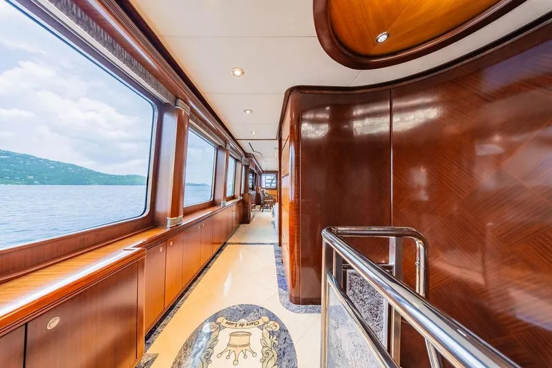 Just Enough Yacht Photos Pics Luxurious interior of 2012 Ares Custom Marine Custom 141 yacht with wood paneling and ocean view.