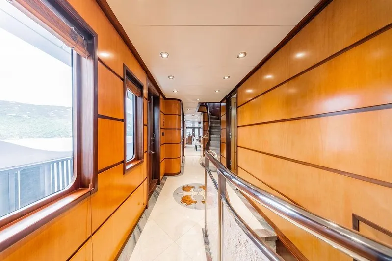 Just Enough Yacht Photos Pics Luxurious interior hallway of 2012 Ares Custom Marine 141 yacht, featuring elegant wood paneling.