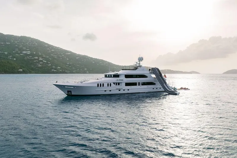 Just Enough Yacht Photos Pics Luxury yacht Ares Custom Marine 141, 2012, with slide, anchored in scenic waters.