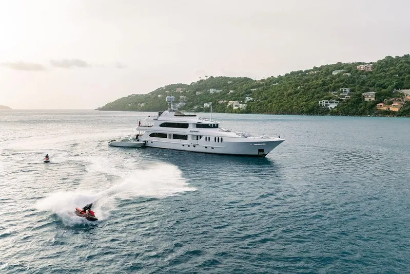 Just Enough Yacht Photos Pics Luxury yacht Ares Custom Marine 141, 2012, with jet skis in scenic coastal waters.