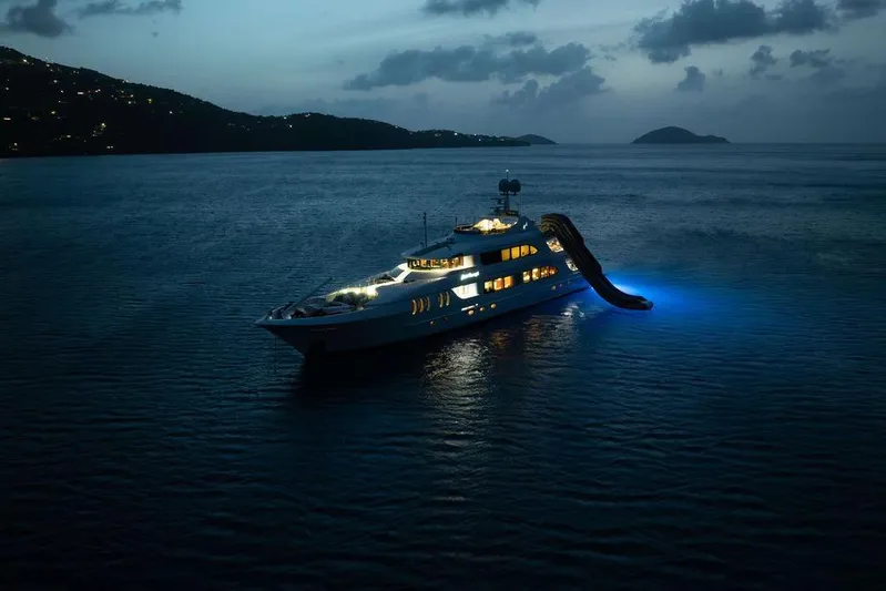 Just Enough Yacht Photos Pics Luxurious 2012 Ares Custom Marine 141 yacht illuminated at night with water slide.