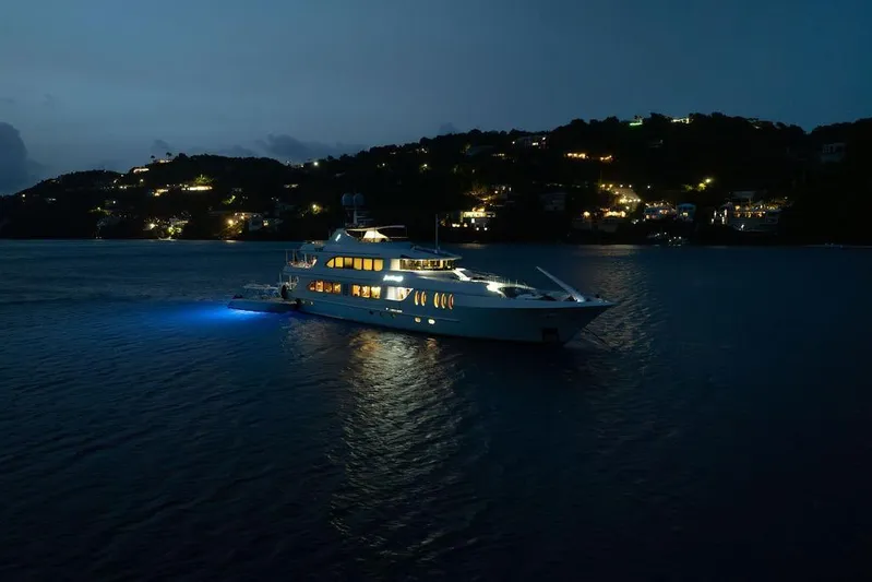 Just Enough Yacht Photos Pics Luxurious 2012 Ares Custom Marine 141 yacht illuminated at night on serene waters.
