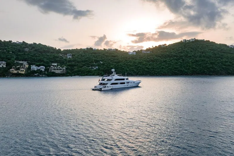 Just Enough Yacht Photos Pics Luxury yacht Ares Custom Marine 141 cruising near lush coastline at sunset, 2012 model.